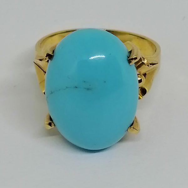 Bague or avec grosse turquoise.