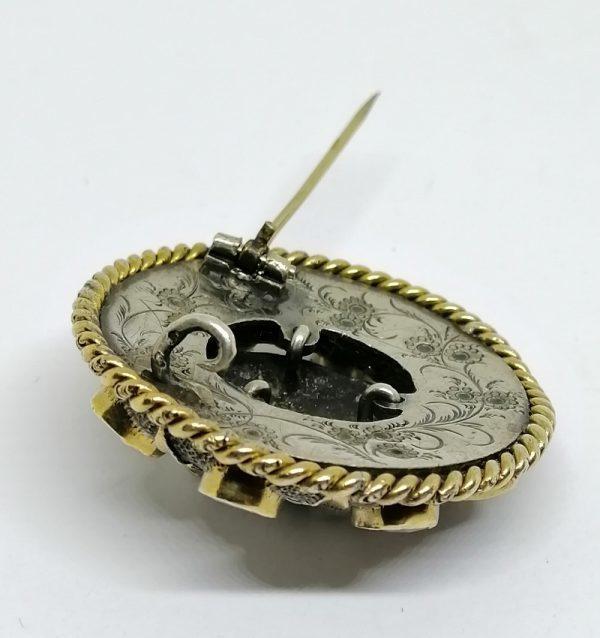 broche en argent et vermeil avec tête d'enfant et sertie de grenats facettés vers 1870