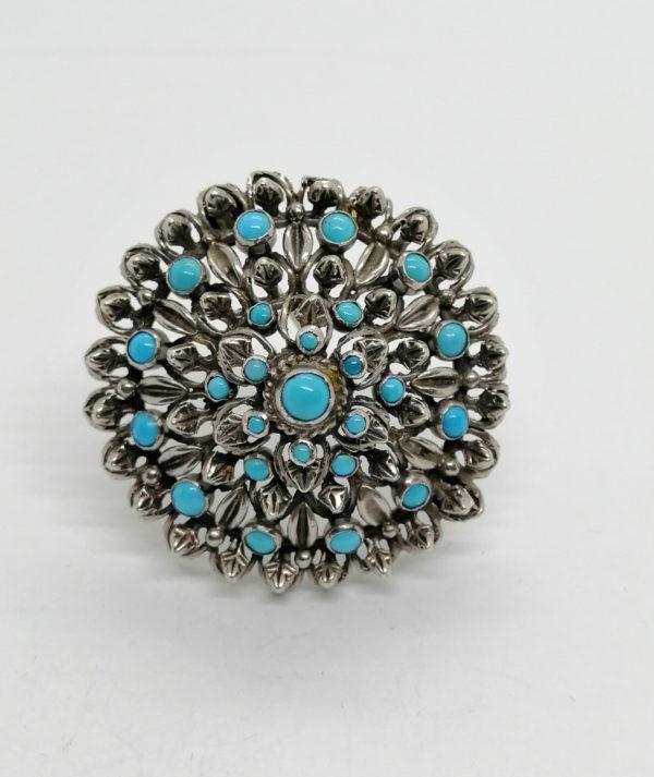 Broche/pendentif argent , ronde et ajourée, sertie de turquoises cabochons.