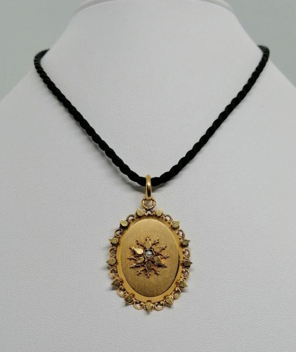 Pendentif en or rosé, ouvragé et au centre perle fine, 1920-30.