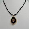 Pendentif/cassolette en or rosé, de forme ovale et plaques d'onyx, 1900-20.