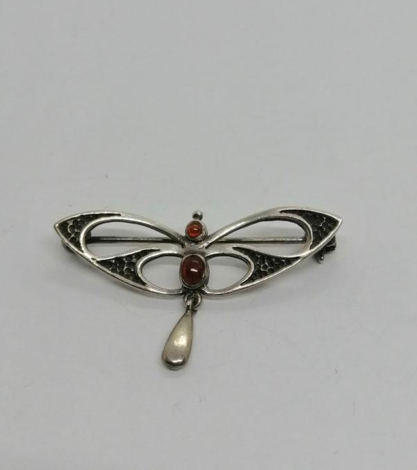 Broche argent, forme typique de l'Art Nouveau, avec petits cabochon de pierres.