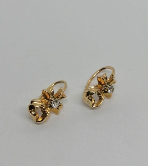 Paire de boucles d'oreilles or jaune, modèle façon ruban et pierre blanche, vers 1920.