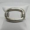 Bracelet argent, jonc ouvrant martelé, et grosse boucle, signé Fabrice Pelletier, 1960-80.