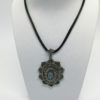Pendentif argent, ajouré, bombé, et pavage de marcasites et de demi perle bleu, 1920-30.