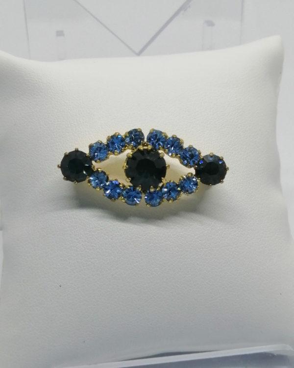 Broche, laiton jaune et strass de couleur bleu, vers 1930-50.