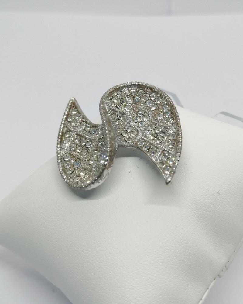 Broche façon ailes d'ange, totalement pavée de strass blanc, vers 1960-70.